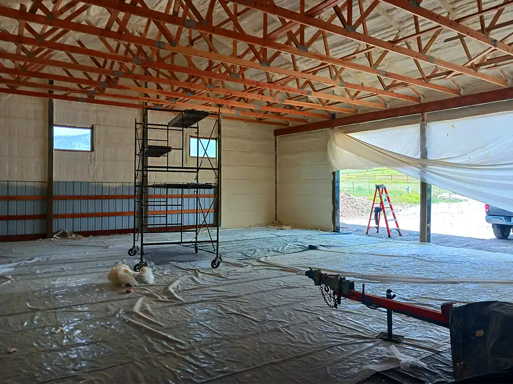 Interior of a large building with spray foam insulation installed along walls and roof